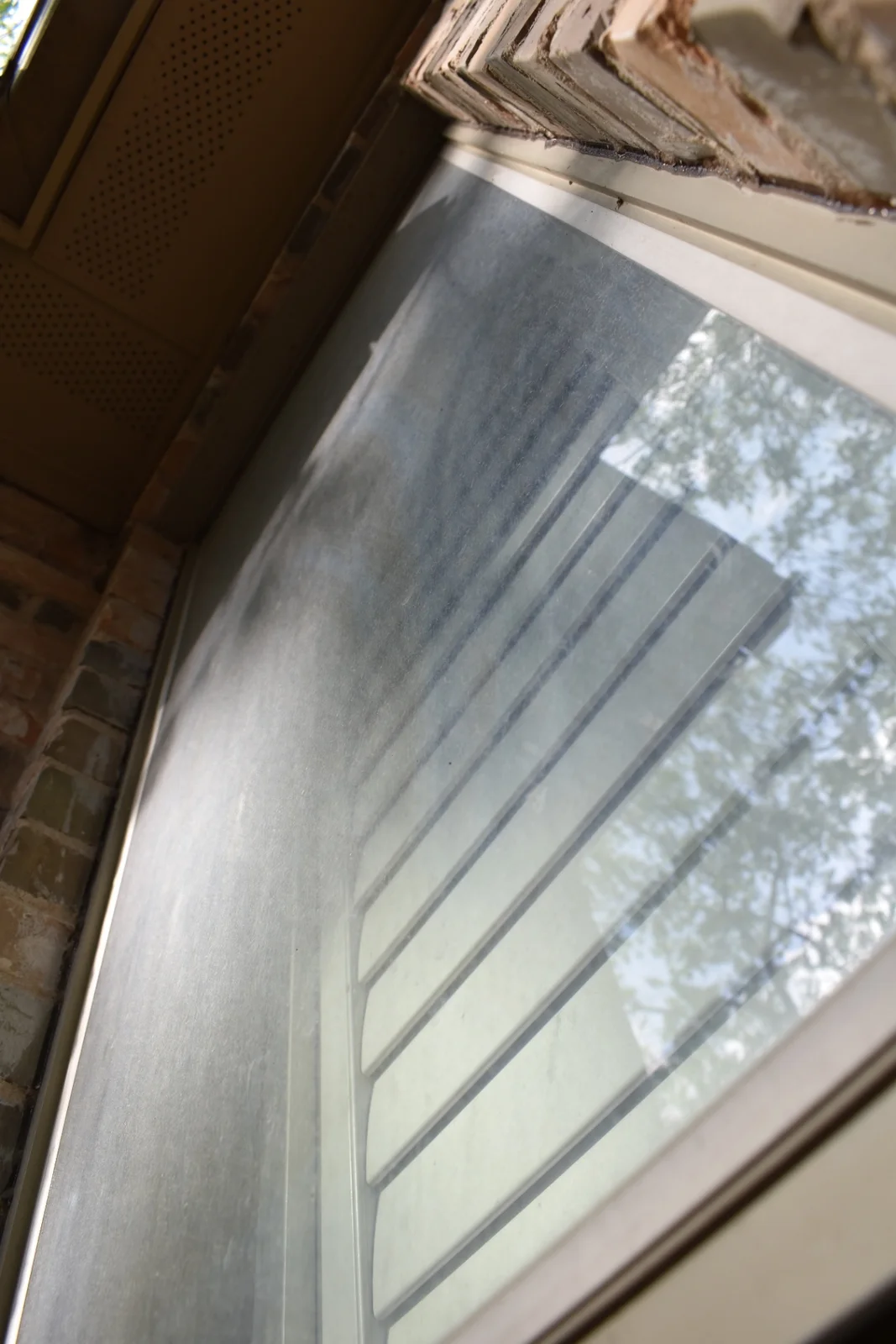 Close-up of exterior window glass before professional restoration at a Dallas-area home