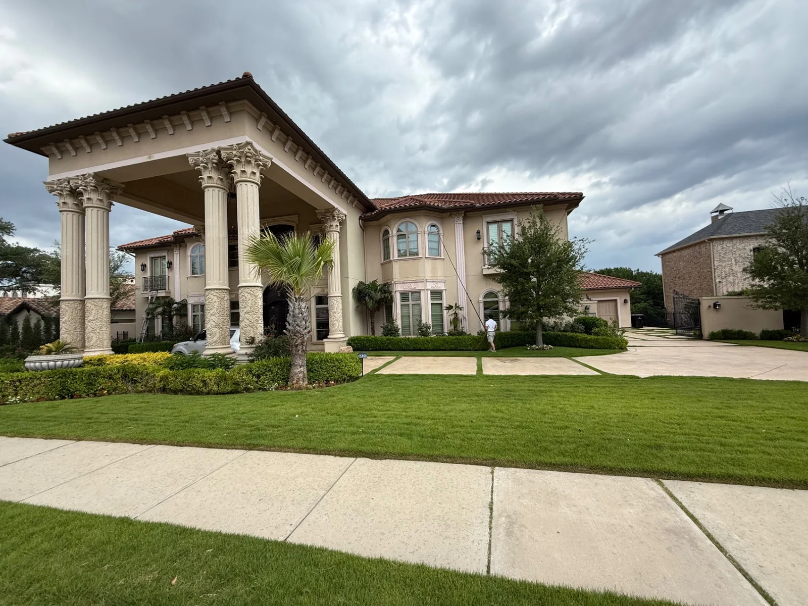 Professional multi-story window cleaning at a grand Dallas estate with classical columns