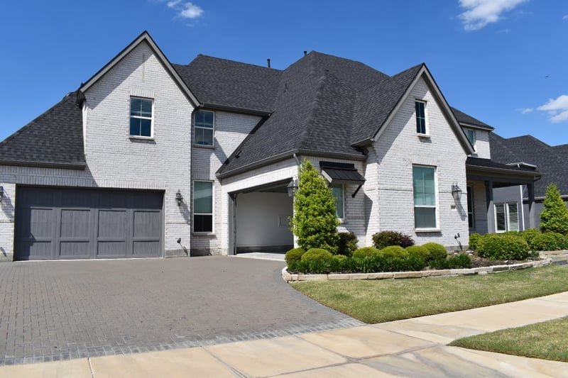 Professional window cleaning at a manicured white-brick luxury home in North Dallas, TX