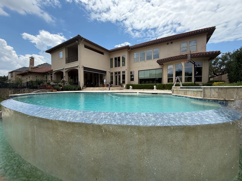 Professional window cleaning at a multi-story poolside estate in the Dallas-Fort Worth area
