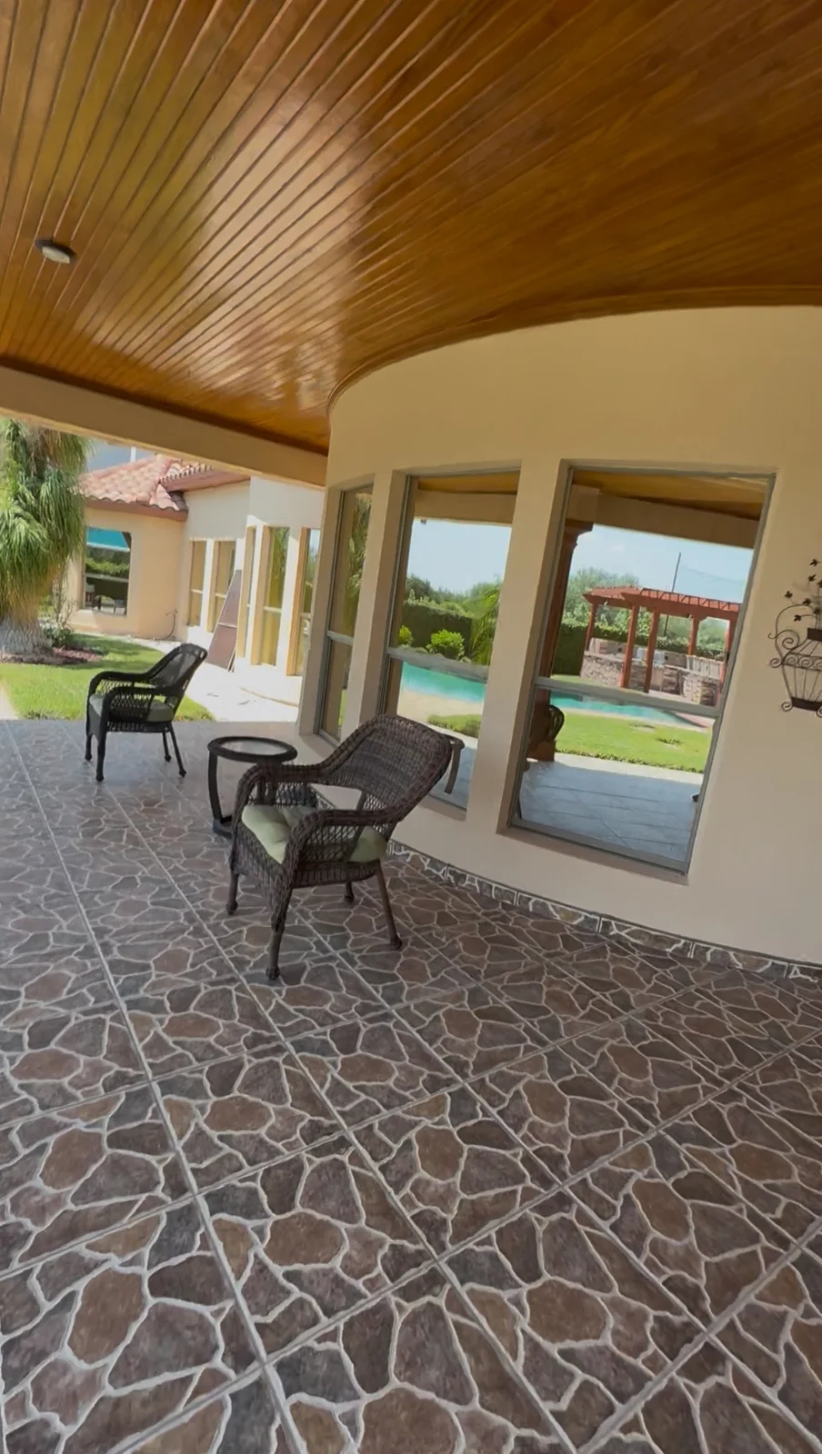 Clean residential windows along a covered poolside patio after professional detailing