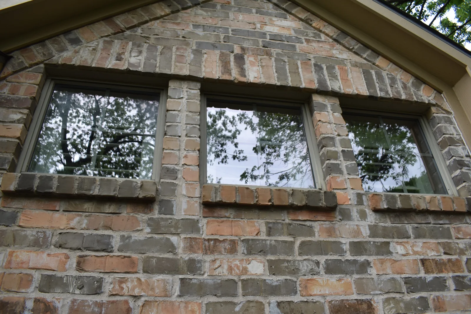 Clean upper-story windows with clear reflections on a brick home in North Dallas, TX