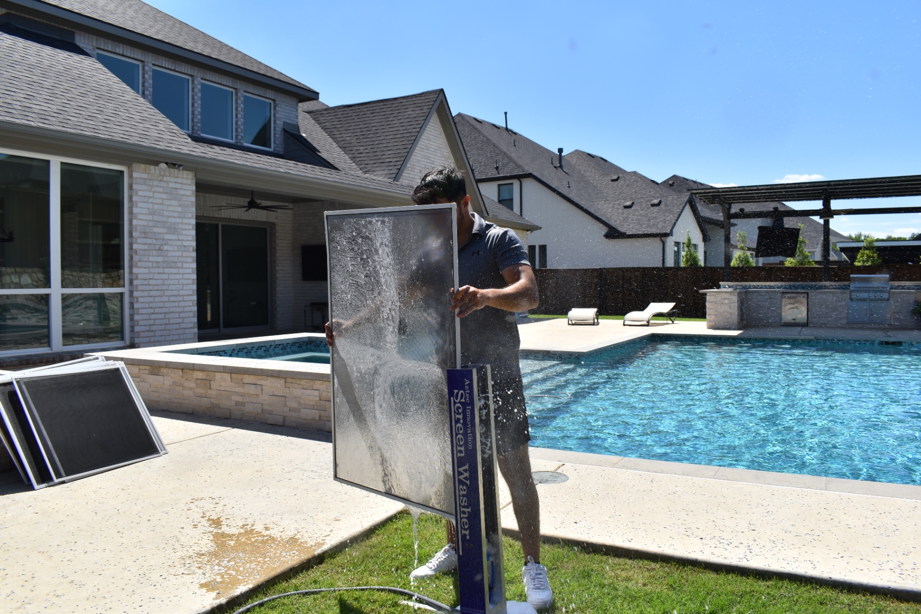 Professional window screen cleaning at an upscale residential property