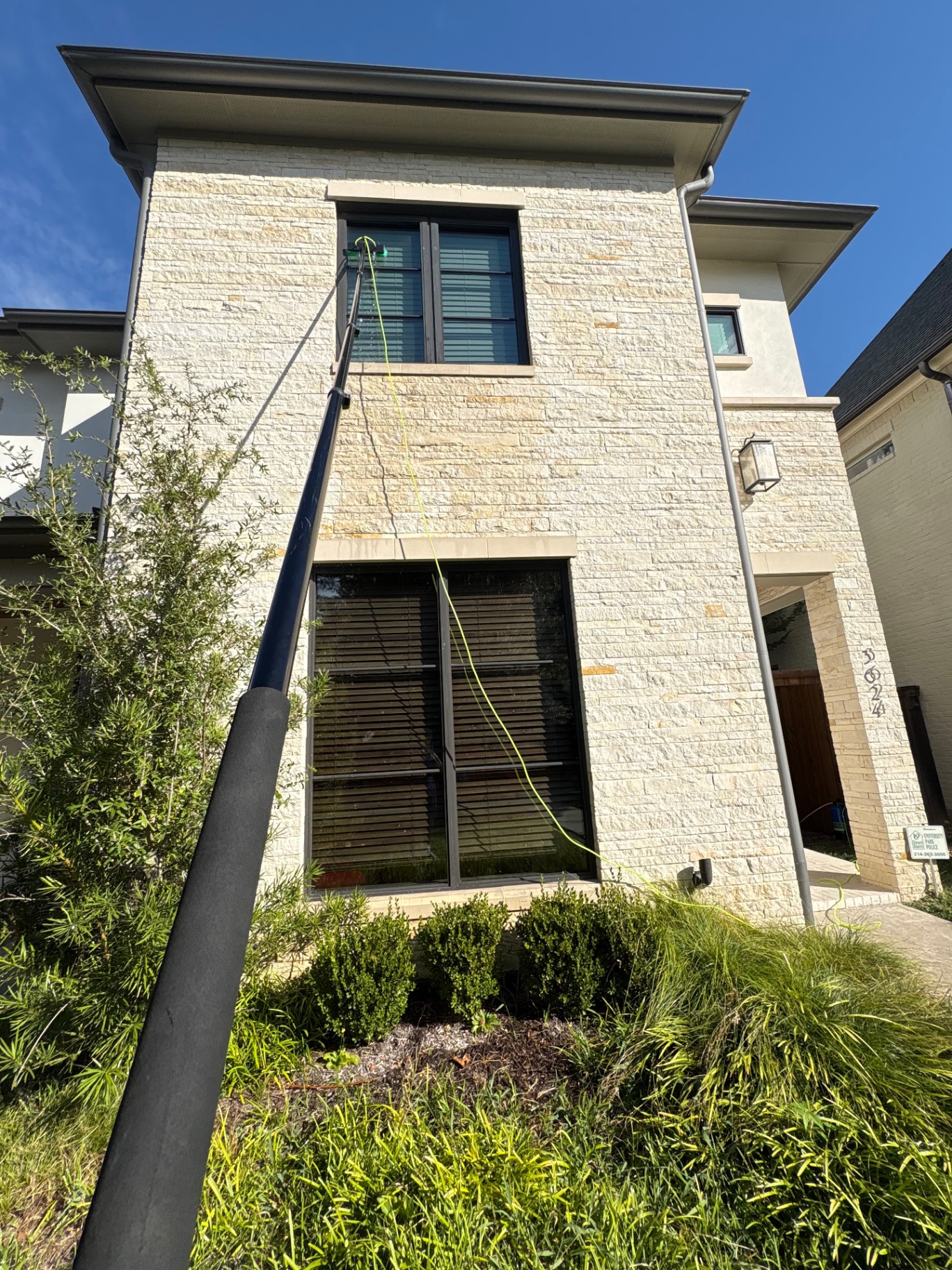 Exterior window cleaning on a custom stone residence
