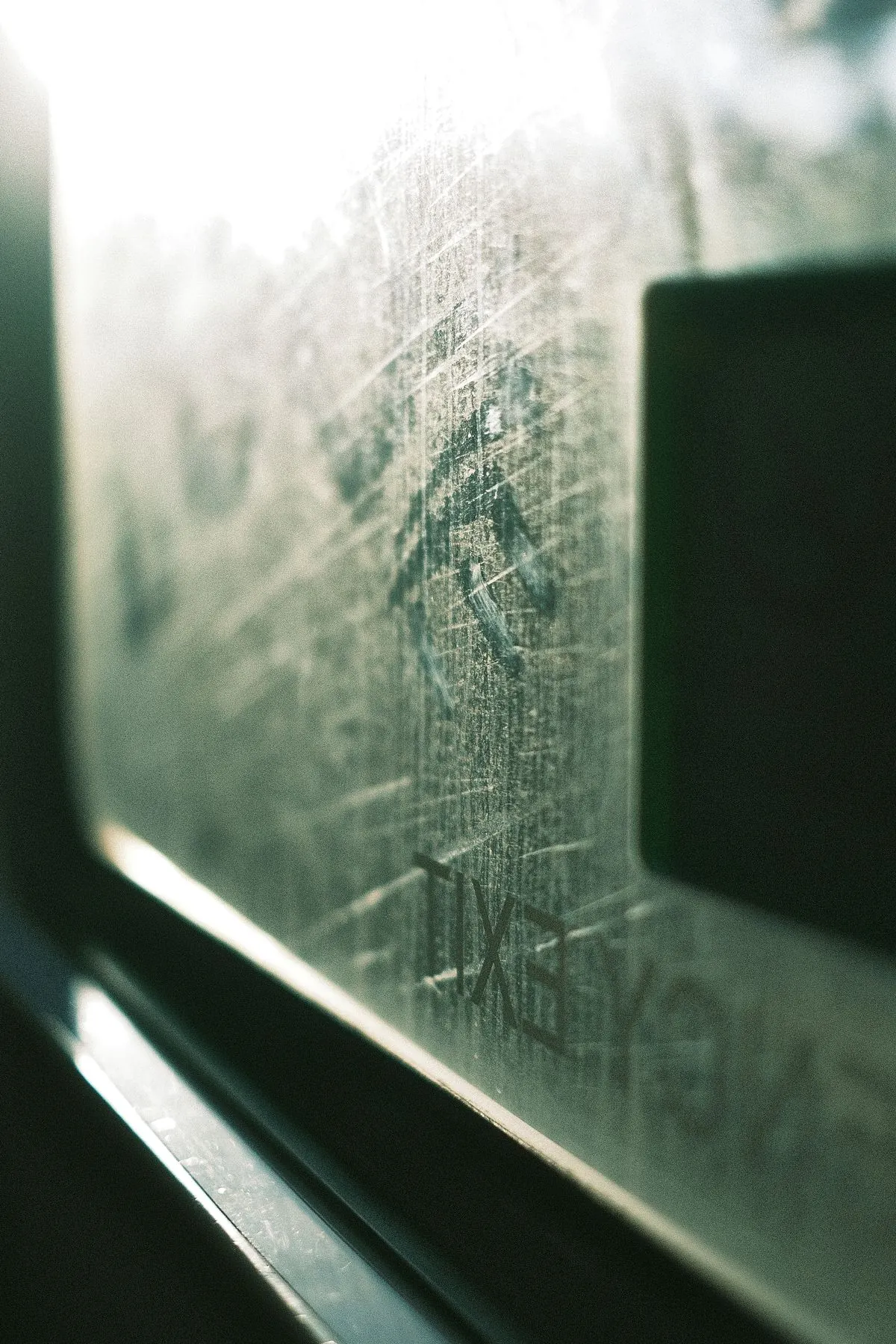 Glass pane marked with hard water spots and mineral streaks